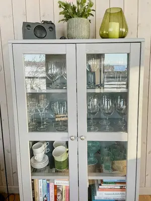 a cabinet filled with wine glasses and books at Enjoy The Calm Setting Of This Cozy Family Cabin in Etnedal