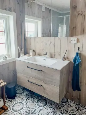 a bathroom with a sink and a mirror at Fantastic View Cabin In Peaceful Blefjel in Lampeland