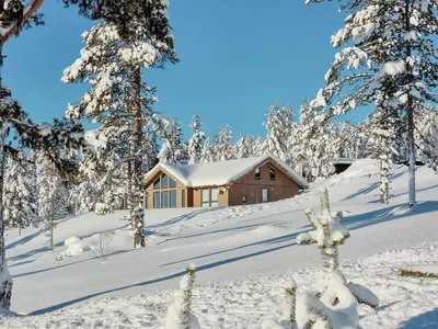 a cabin in the snow with snow covered trees at Experience Mountain Magic At Bringsfjellet in Lalm