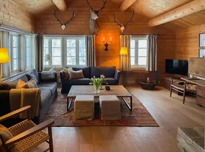 a living room with a couch and a table at Traditional Cabin In Gålå With Stunning Nature in Gålå