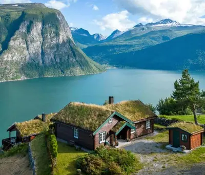 an island in a lake with a mountain at Panoramic Cabin With Fjord Views In Valldal in Valldal