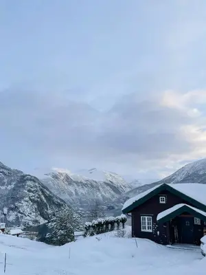 a cabin in the snow with mountains in the background at Panoramic Cabin With Fjord Views In Valldal in Valldal