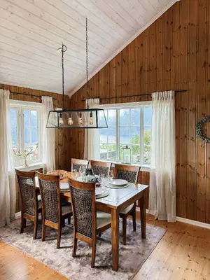 a dining room with a table and chairs at Panoramic Cabin With Fjord Views In Valldal in Valldal