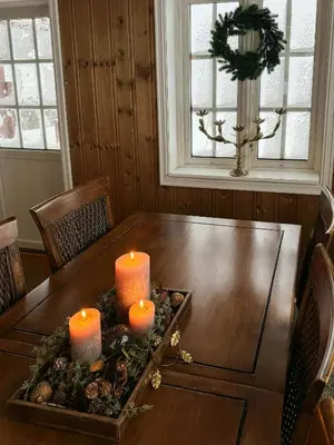 a table with three candles on top of it at Panoramic Cabin With Fjord Views In Valldal in Valldal