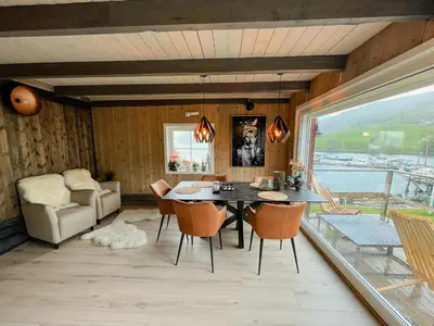 a dining room with a table and chairs at Unique Modern Harbour Home In Valsøyfjord in Valsøyfjord