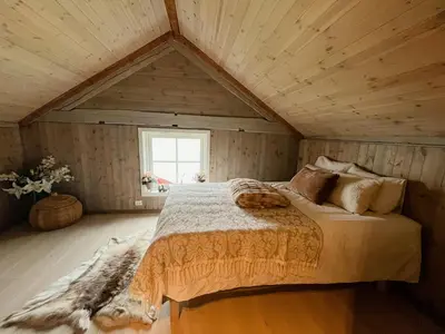 a bedroom with a large bed in a attic at Unique Modern Harbour Home In Valsøyfjord in Valsøyfjord