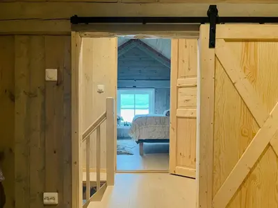 a door leading to a bedroom in a log cabin at Unique Modern Harbour Home In Valsøyfjord in Valsøyfjord