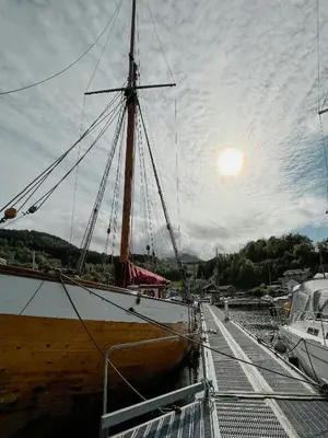 a large boat is docked at a dock at Unique Modern Harbour Home In Valsøyfjord in Valsøyfjord