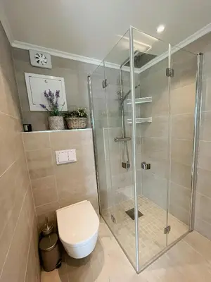 a bathroom with a toilet and a glass shower at Unique Modern Harbour Home In Valsøyfjord in Valsøyfjord