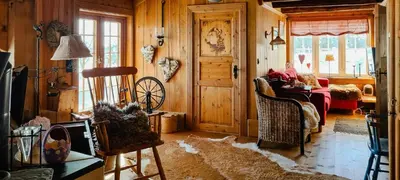 a living room with wood paneling and a room with a door at Cozy Cabin With A Beautiful View in Øygardsgrend