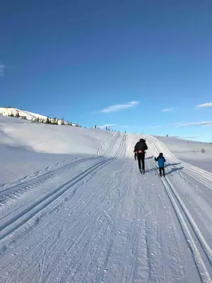 a man and a child on skis in the snow at Cabin By Selbusjøen With Ski And Trail Access in Selbu