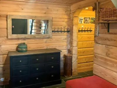 a room with a dresser and a mirror in a cabin at Idyllic Log Cabin At Nordseter in Lillehammer