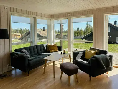a living room with a couch and two chairs and a table at Cozy Cabin In Beautiful Area Near Lillehammer in Lillehammer