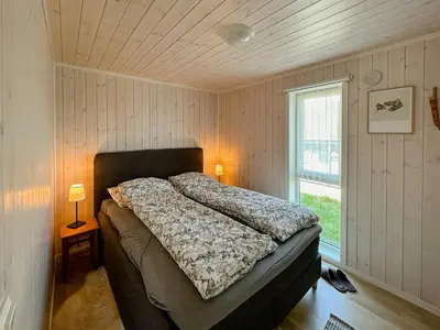 a bedroom with a bed in a room with a window at Cozy Cabin In Beautiful Area Near Lillehammer in Lillehammer