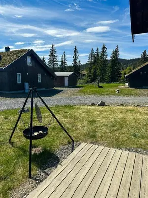 a playground with a frisbee in the middle of a yard at Cozy Cabin In Beautiful Area Near Lillehammer in Lillehammer