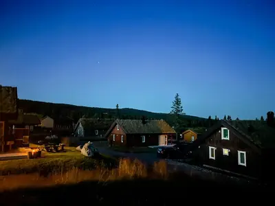 a group of houses in a village at night at Cozy Cabin In Beautiful Area Near Lillehammer in Lillehammer