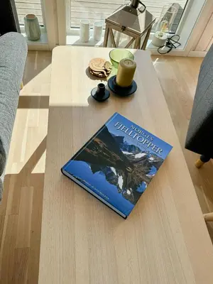 a book sitting on top of a coffee table at Cozy Cabin In Beautiful Area Near Lillehammer in Lillehammer