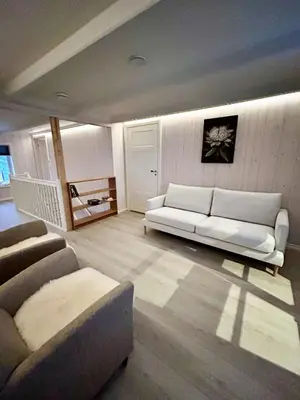 a living room with a white couch and chairs at Charming & Modern Seaside House In Valsøyfjord in Valsøyfjord