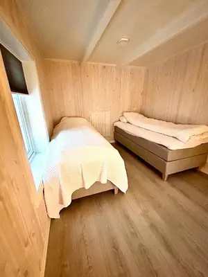 a small bedroom with a bed and a window at Charming & Modern Seaside House In Valsøyfjord in Valsøyfjord