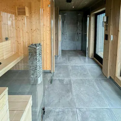 a large bathroom with a shower and a tile floor at Architect Mountain Cabin At Lygna With Views in Jaren