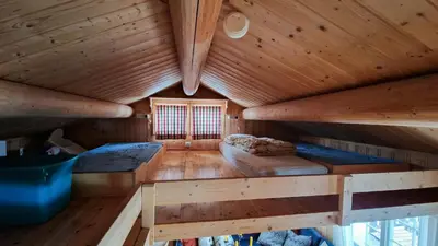 an inside view of a log cabin with two beds at Charming Cabin With Views In Valdres in Aurdal