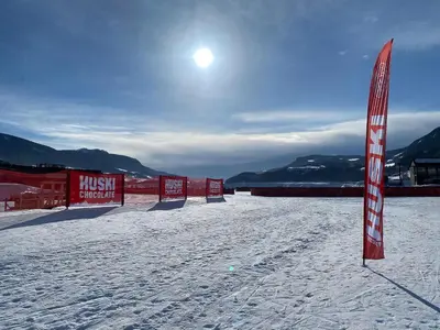 a row of signs in the snow with the sun at Lovely, New Apartment At Kvitfjell With Ski-In Out in Fåvang