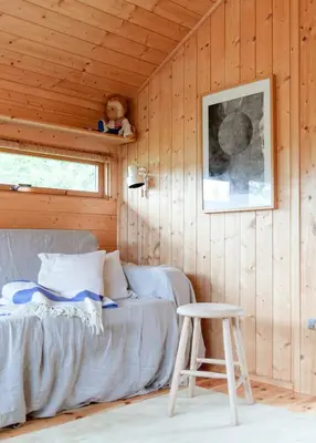 a bedroom with a bed and a stool in a room at Architectural Gem Near Cross Country Trails in Eggedal