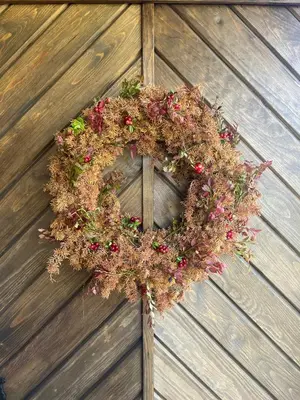 a wreath is hanging on a wooden door at Fantastic Forest Cabin With Panoramic View in Jaren