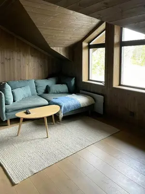 a living room with a couch and a coffee table at Spacious Mountain Cabin With Fantastic Views in Ål
