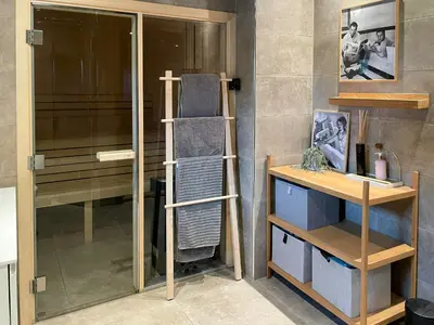 a room with a shower with a ladder and a shelf at Spacious Mountain Cabin With Fantastic Views in Ål