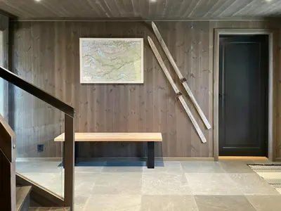 a room with a bench and a map on the wall at Spacious Mountain Cabin With Fantastic Views in Ål