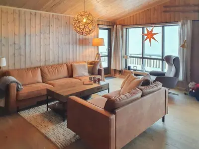 a living room with a couch and a table at Cozy Ambiance And Trails At Skeikampen in Svingvoll