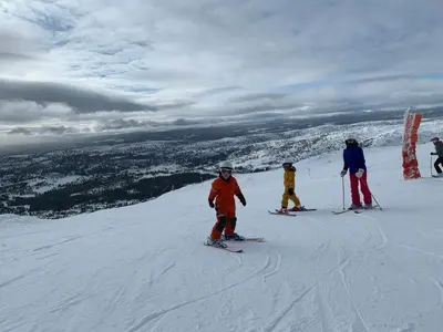 a group of people skiing down a snow covered slope at Cozy Ambiance And Trails At Skeikampen in Svingvoll