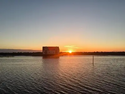 a sunset over a large body of water at Unique House On The Waterfront On Veiholmen in Smøla