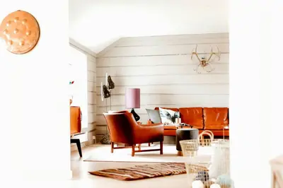 a living room with a couch and a table at Unique House On The Waterfront On Veiholmen in Smøla