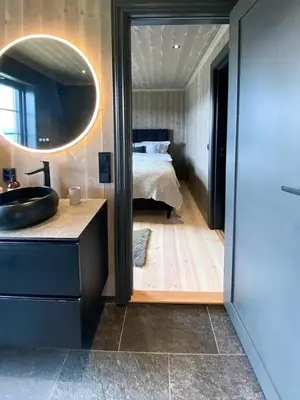 a bathroom with a sink and a bedroom with a bed at Adventure And Relaxation In Voss in Vossevangen
