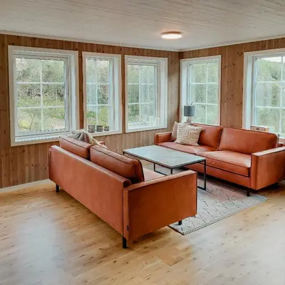 a living room with two couches and a table at Unique Cabin By The Ski Slope In Hovden in Hovden