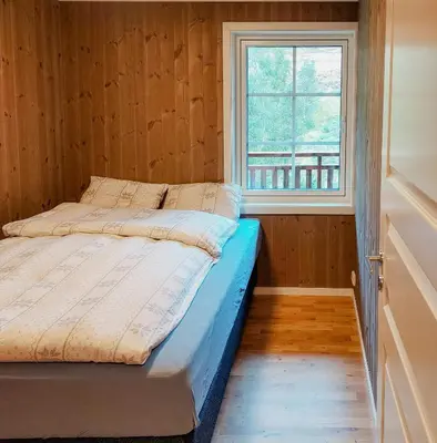 a bed in a room with a window at Unique Cabin By The Ski Slope In Hovden in Hovden