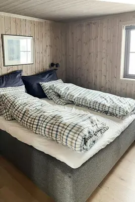 two beds sitting in a room with at Nature-Close Cabin By The Water in Eggedal