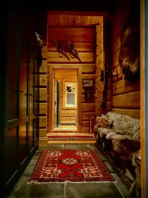 a room with a door and a rug and a window at Rustic Log Cabin At The Foot Of Hardangervidda in Uvdal