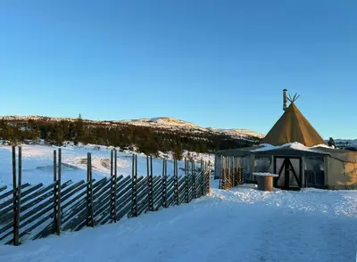 a yurt in the snow next to a fence at Cabin With Panoramic Views In Turufjell in Flå