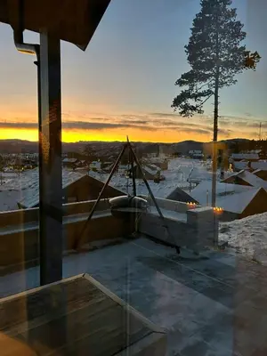 a view of a snow covered city at sunset at Cabin With Panoramic Views In Turufjell in Flå