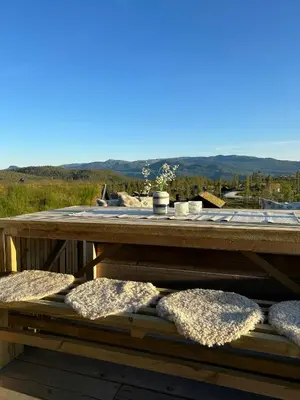 a wooden table with pillows on it with a view at Cabin With Panoramic Views In Turufjell in Flå