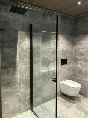 a bathroom with a toilet and a glass shower at Cabin With Panoramic Views In Turufjell in Flå