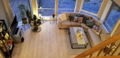 a living room with a couch and a table at Seaside Dream Cabin With Jacuzzi in Steinsland