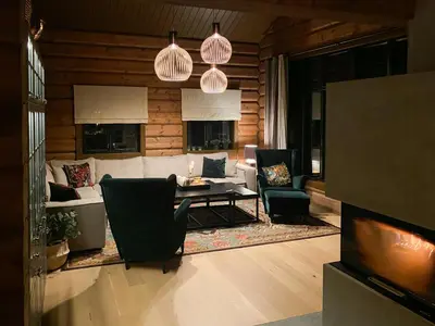 a living room with a couch and a table and chairs at Timber Cabin With Fantastic View In Oppdal in Oppdal