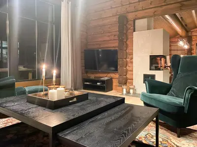 a living room with a coffee table and a tv at Timber Cabin With Fantastic View In Oppdal in Oppdal