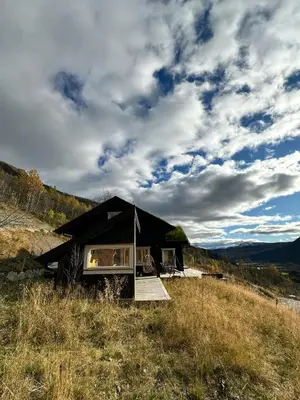 a black tent sitting on top of a hill at Mountain Cabin Near Solheisen In Grøndalen in Hemsedal