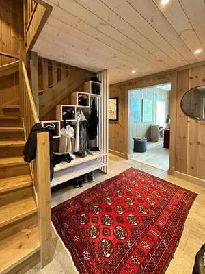 a room with a staircase and a red rug at Mountain Cabin Near Solheisen In Grøndalen in Hemsedal