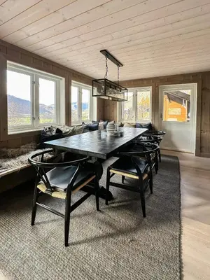 a dining room with a large wooden table and chairs at Mountain Cabin Near Solheisen In Grøndalen in Hemsedal